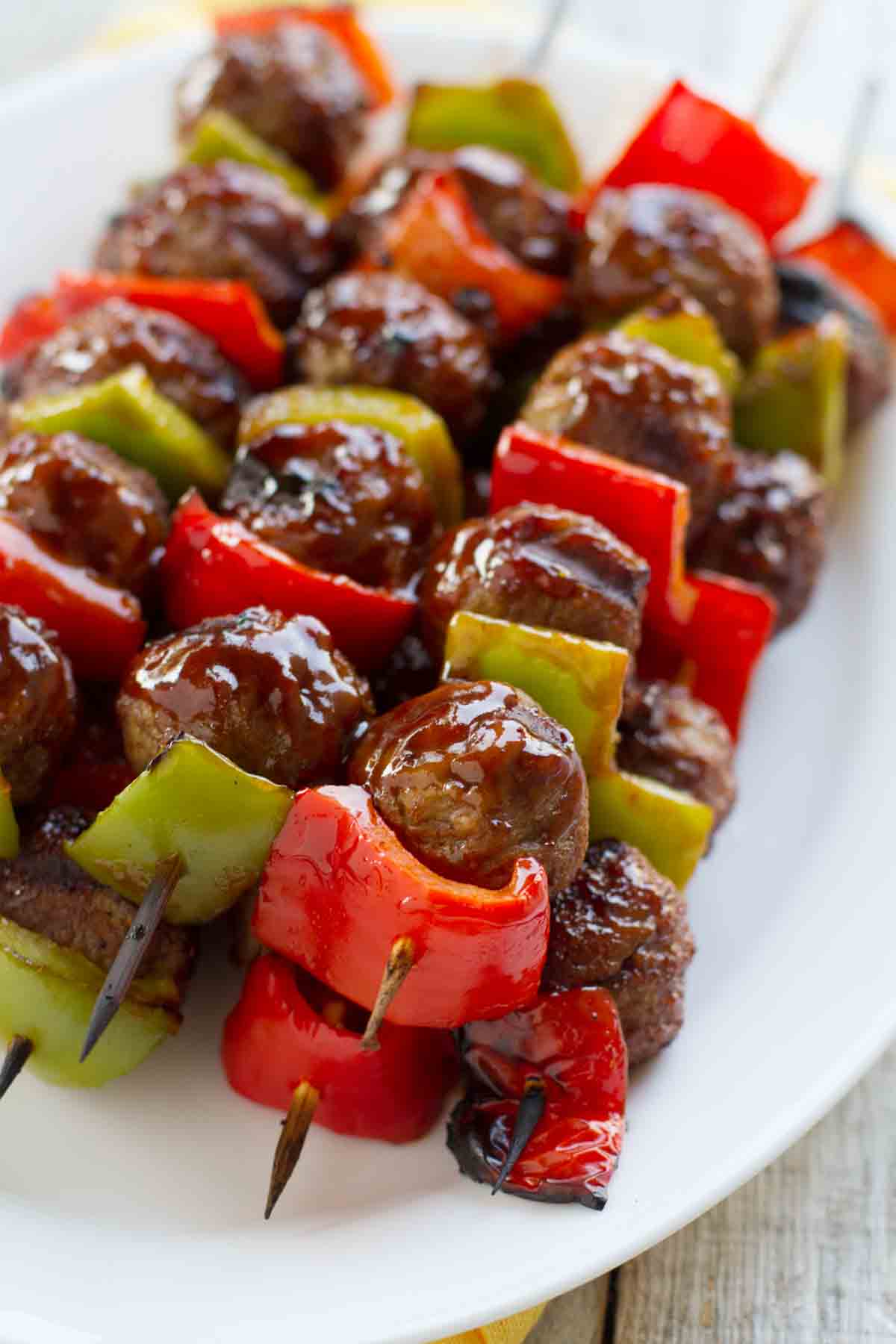 Sweet and Sour Meatball Skewers stacked on a plate