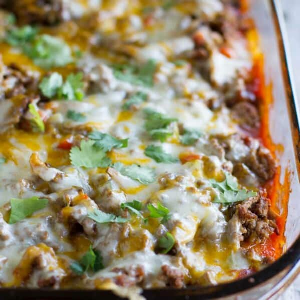 Biscuits are coated in taco sauce then topped with spiced ground beef and lots of cheese in this family friendly Taco Casserole.