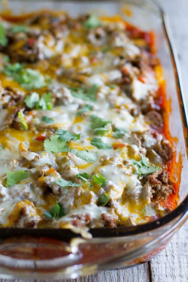 Biscuits are coated in taco sauce then topped with spiced ground beef and lots of cheese in this family friendly Taco Casserole.