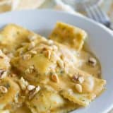 Ravioli with Pumpkin Alfredo Recipe - Pumpkin, sage and nutmeg add a warm richness to this Alfredo recipe that is served over ravioli for a comforting and easy fall or winter dinner.