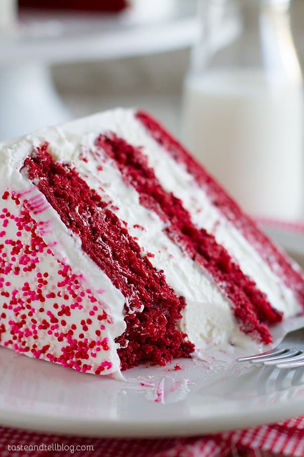 Slice of red velvet ice cream cake with a bite taken from it.