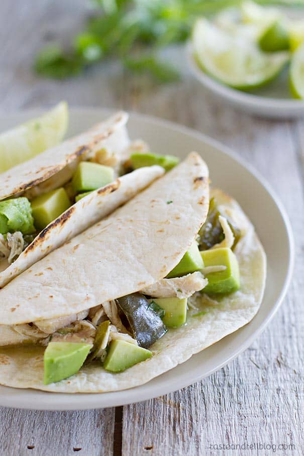 Easy Slow Cooker Chicken Tacos - chicken thighs are cooked all day in a salsa verde sauce for easy yet amazing tacos.