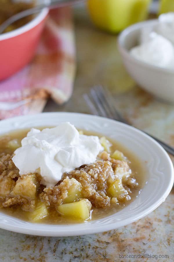 Easy Apple Crumble with Oatmeal and Coconut - Baked apples are topped with a mixture of steel cut oats and coconut in this easy apple crumble.  Top it off with homemade whipped cream for an easy dessert that everyone will love.