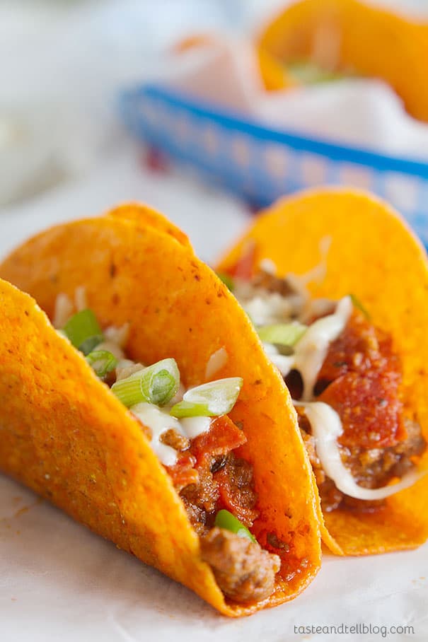 Meat Lovers Pizza Tacos - Cheesy taco shells are filled with a meaty mixture of ground beef, sausage and pepperoni with pizza sauce in these tacos that are perfect for Meat Lovers Pizza lovers.