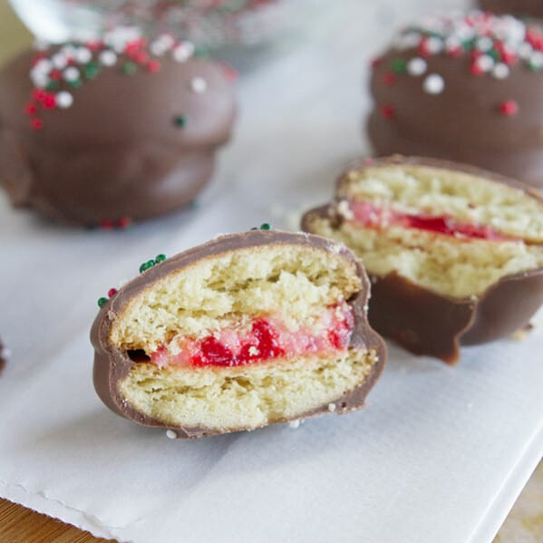 Chocolate Cherry Sandwich Cookies - Vanilla wafers are filled with a cherry cream cheese mixture, then dipped in chocolate in these fun cookies.