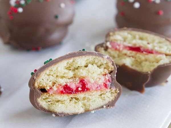 Chocolate Cherry Sandwich Cookies - Vanilla wafers are filled with a cherry cream cheese mixture, then dipped in chocolate in these fun cookies.