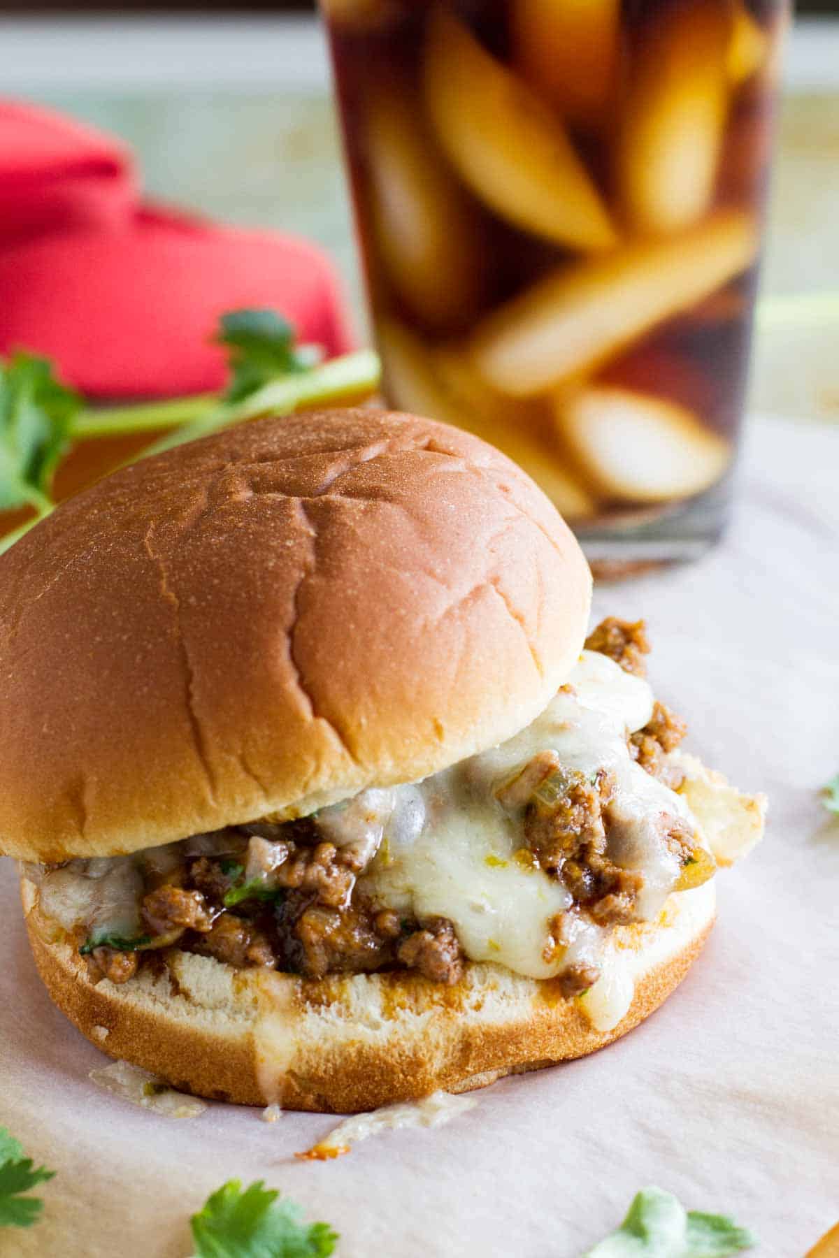 Not your typical sloppy joe recipe, these sloppy joes have an enchilada twist with delicious tex-mex flavors. They are the best sloppy joe recipe! Enchilada Sloppy Joe with melted cheese.