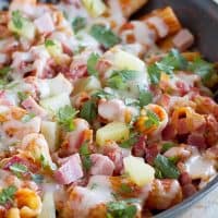 Keep dishes to a minimum with this easy one pan pasta with the flavors of a Hawaiian pizza - ham, bacon, pineapple and gooey cheese.