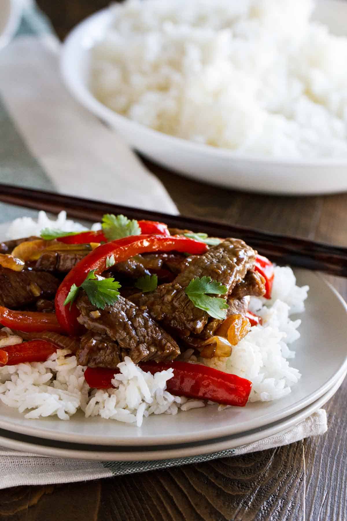 Plate with a serving of rice topped with steak stir fry