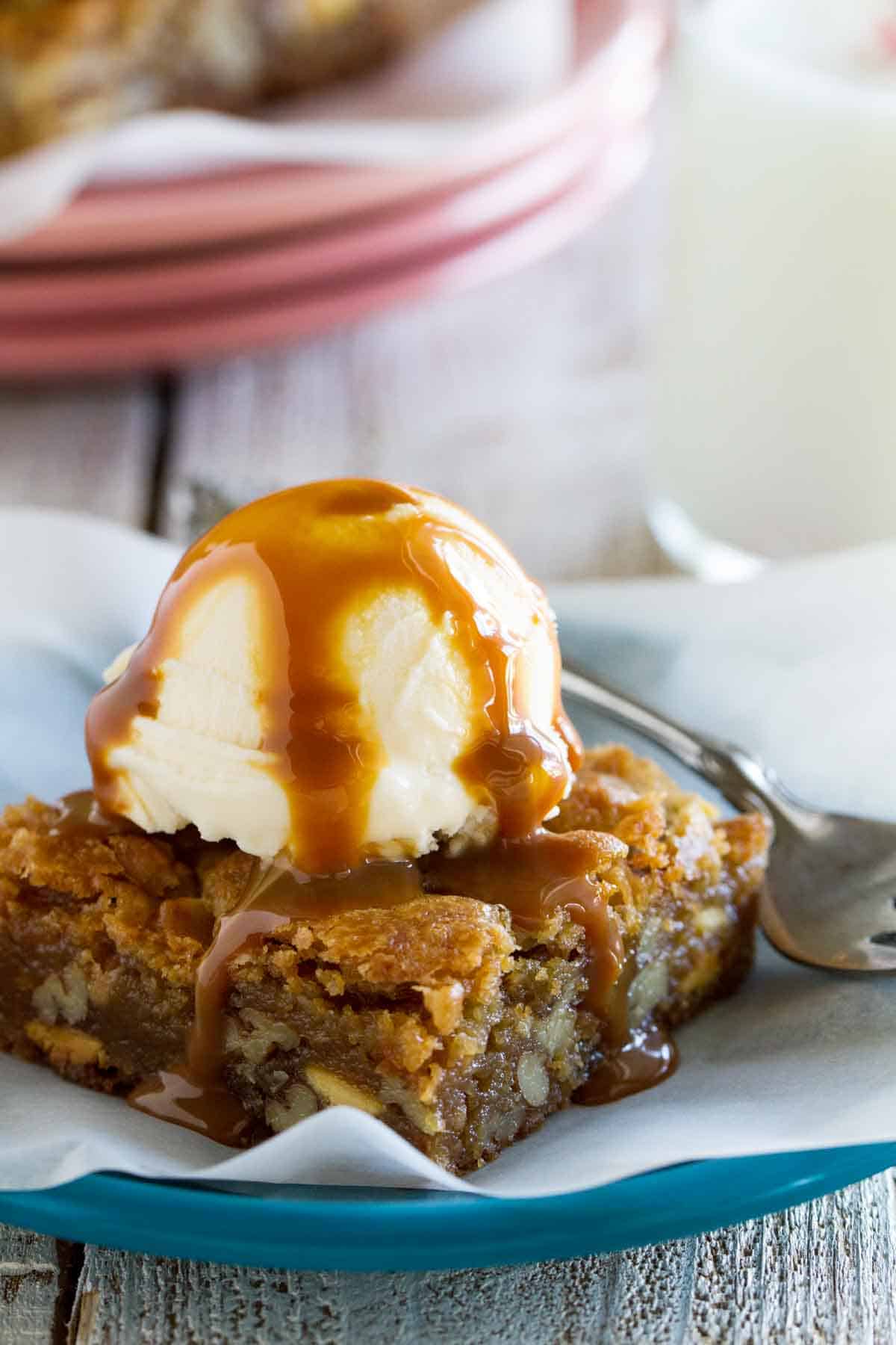 Blondie on a plate topped with ice cream and caramel