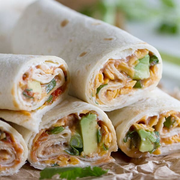 These Vegetarian Wraps with Beans and Cheese make the perfect grab and go lunch. Filled with cream cheese, refried beans, cheese, salsa, green onions, cilantro and avocado, they will make your taste buds will be happy!