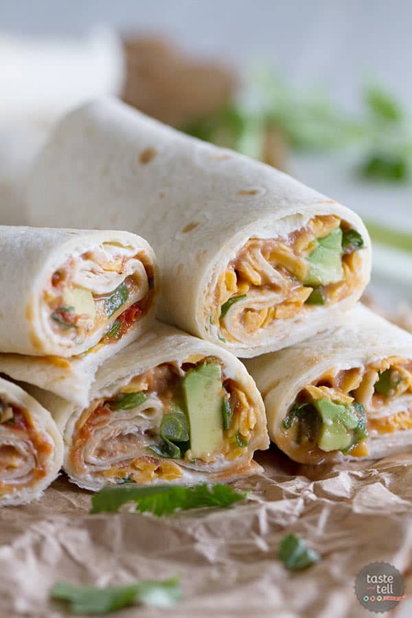 These Vegetarian Wraps with Beans and Cheese make the perfect grab and go lunch.  Filled with cream cheese, refried beans, cheese, salsa, green onions, cilantro and avocado, they will make your taste buds happy!