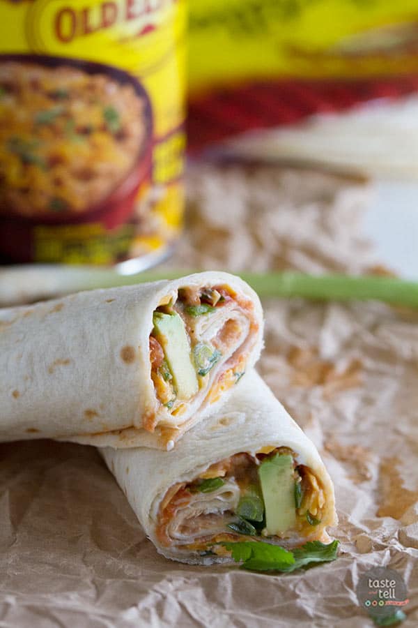 These Vegetarian Wraps with Beans and Cheese make the perfect grab and go lunch.  Filled with cream cheese, refried beans, cheese, salsa, green onions, cilantro and avocado, they will make your taste buds happy!