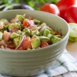 bowl of avocado and tomato salad with red onions