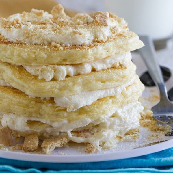 Pancakes for dessert!! These fluffy Cheesecake Pancakes are topped with a cream cheese frosting and graham cracker crumbs for a fun and delicious treat.