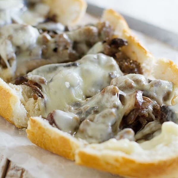 French bread is topped with cooked sausage, portobello mushrooms and cheese in this easy French bread pizza recipe.