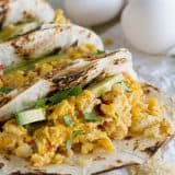 Eat your tacos for breakfast with these breakfast tacos filled with scrambled eggs with onions, jalapeños, tomatoes and crumbled tortilla chips. Migas Breakfast Tacos are a great way to add a little Tex-Mex to your morning!
