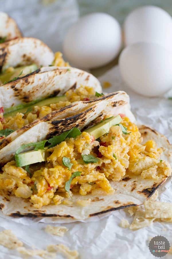 Eat your tacos for breakfast with these breakfast tacos filled with scrambled eggs with onions, jalapeños, tomatoes and crumbled tortilla chips. Migas Breakfast Tacos are a great way to add a little Tex-Mex to your morning!