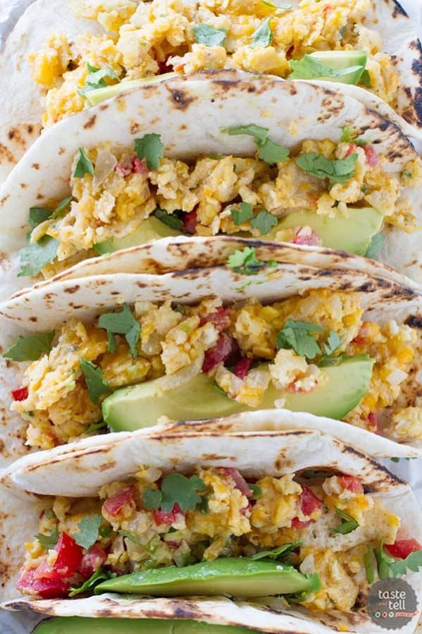 Eat your tacos for breakfast with these breakfast tacos filled with scrambled eggs with onions, jalapeños, tomatoes and crumbled tortilla chips. Migas Breakfast Tacos are a great way to add a little Tex-Mex to your morning!