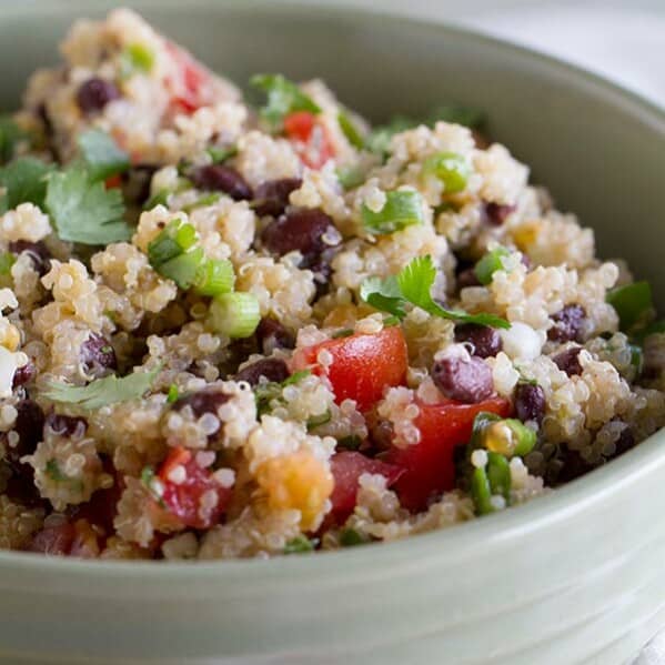 Healthy and satisfying, this Tomato and Black Bean Quinoa Salad is perfect for a pot luck or for a delicious side dish.