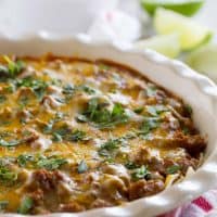 Beef Enchilada Casserole in a dish with cilantro sprinkled on top