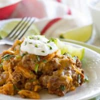 Beef Enchilada Casserole on a Plate topped with sour cream