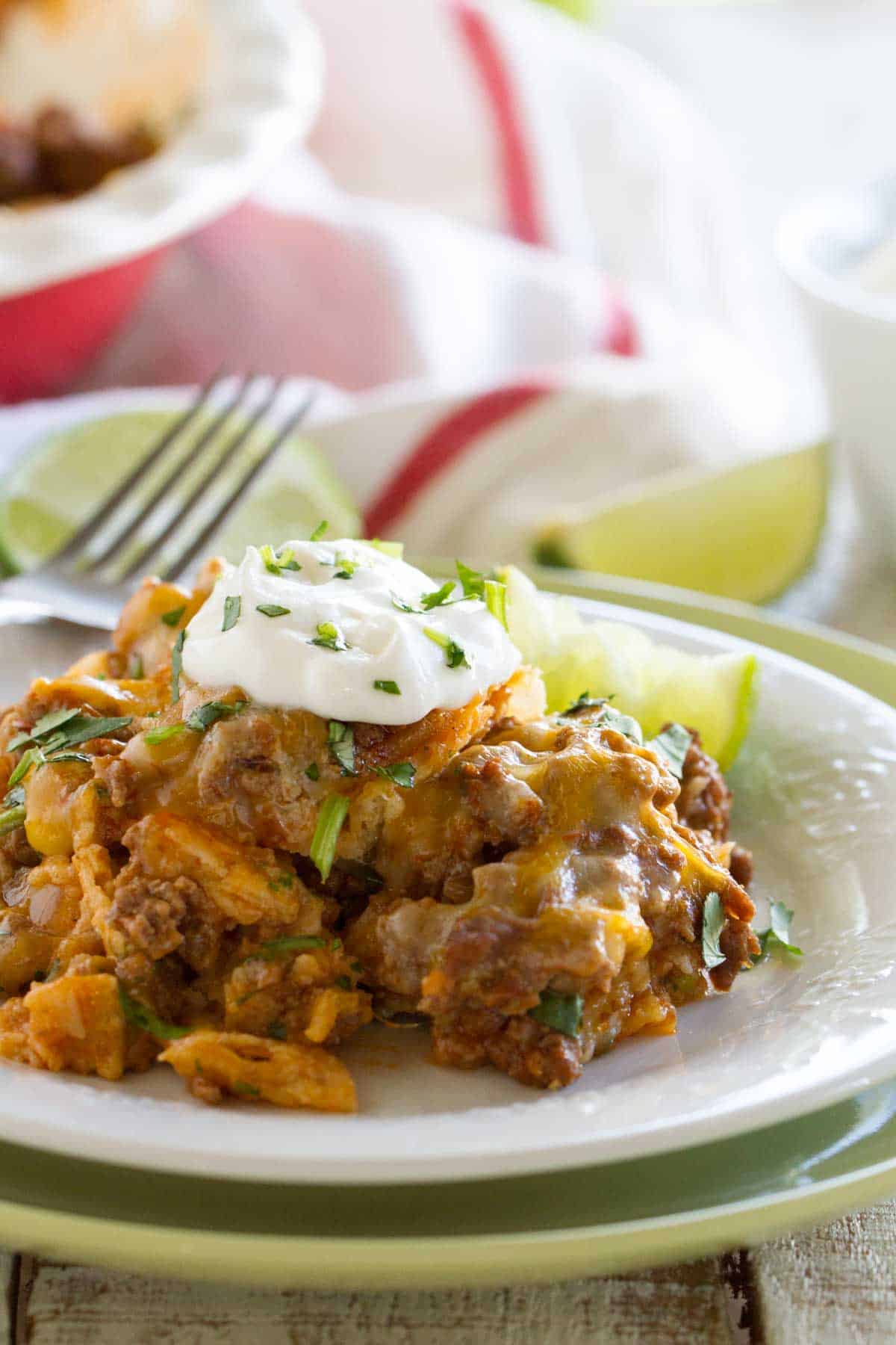 Beef Enchilada Casserole on a Plate topped with sour cream