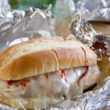 Chicken Parmesan goes sandwich style in these easy and portable Oven Baked Chicken Parmesan Sandwiches. Breaded chicken is topped with marinara, cheese and basil, layered on a roll, then baked in a foil packet.