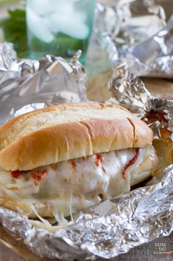 Chicken Parmesan goes sandwich style in these easy and portable Oven Baked Chicken Parmesan Sandwiches. Breaded chicken is topped with marinara, cheese and basil, layered on a roll, then baked in a foil packet.