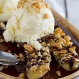 A modern take on the banana split, this Pan-Fried Banana Split recipe coats a banana in sugar and peanuts, then is served up with ice cream and an easy homemade chocolate sauce.