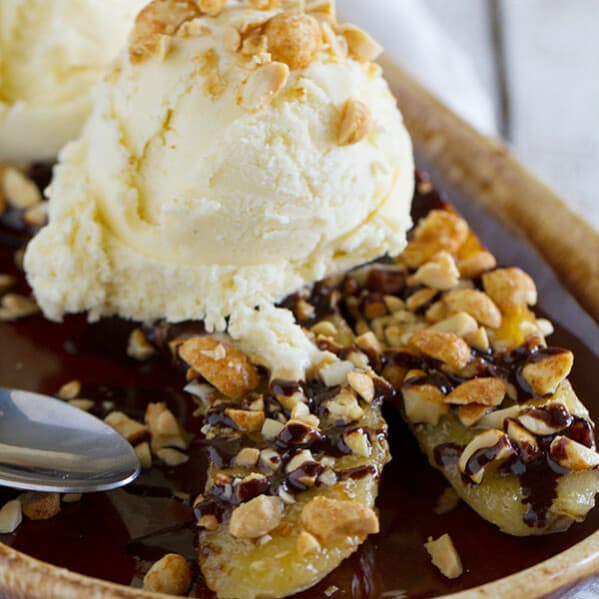 A modern take on the banana split, this Pan-Fried Banana Split recipe coats a banana in sugar and peanuts, then is served up with ice cream and an easy homemade chocolate sauce.