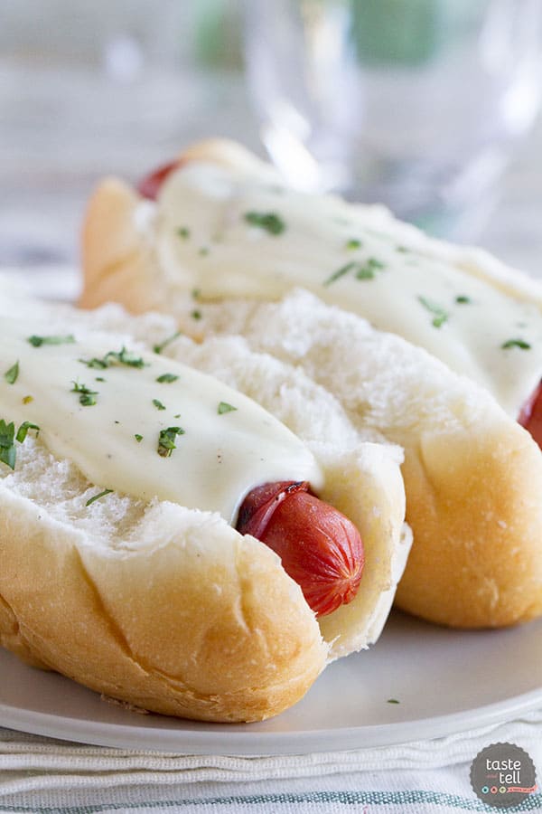 Cordon Bleu Hot Dogs topped with cheese sauce.