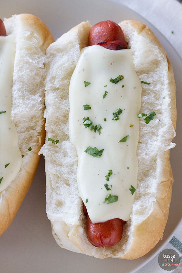 hot dogs wrapped in ham and topped with a creamy cheese sauce.