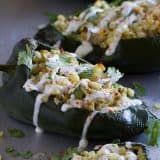 Flavor explosion! These Chicken and Corn Stuffed Chiles are packed with flavor - chicken, corn, cheese and salsa all inside a mild poblano pepper. Don’t skip the lime cream!