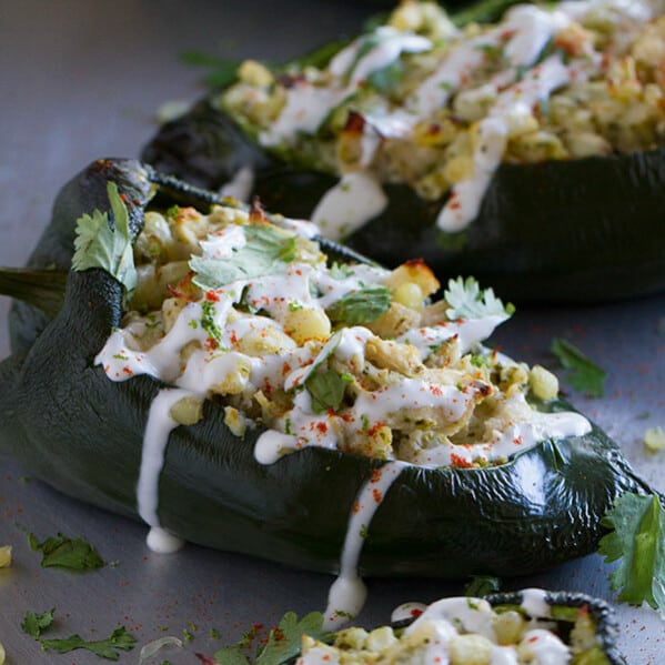 Flavor explosion! These Chicken and Corn Stuffed Chiles are packed with flavor - chicken, corn, cheese and salsa all inside a mild poblano pepper. Don’t skip the lime cream!