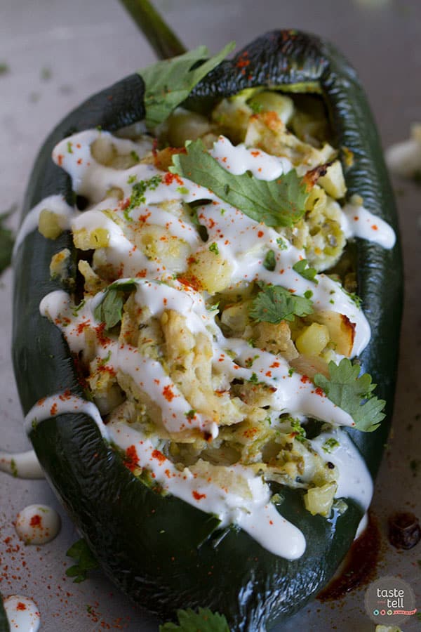 Flavor explosion! These Chicken and Corn Stuffed Chiles are packed with flavor - chicken, corn, cheese and salsa all inside a mild poblano pepper. Don’t skip the lime cream!