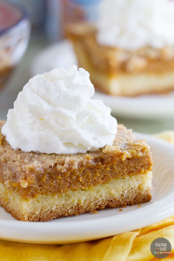 Slice of pumpkin pie cake topped with whipped cream.