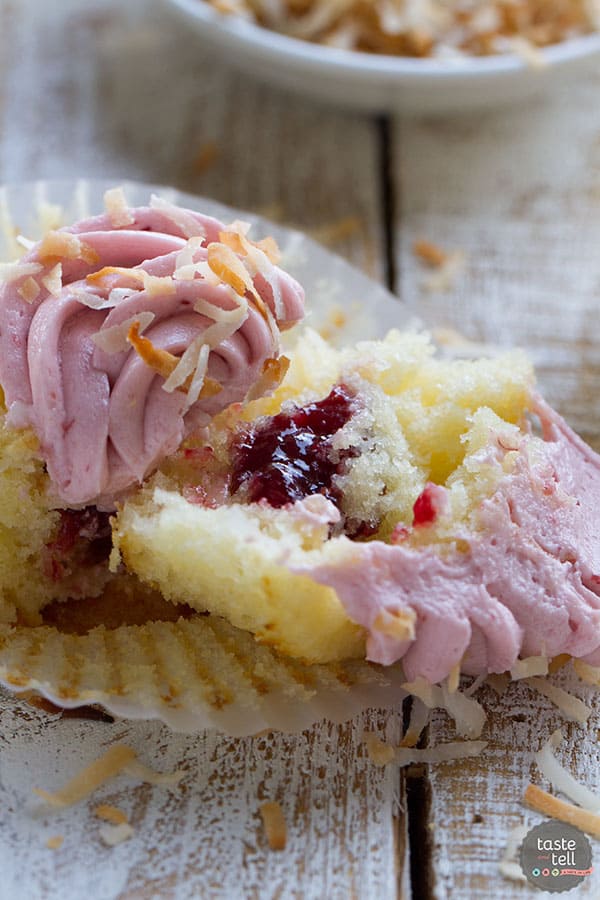 Raspberry Coconut Cupcakes - Coconut cupcakes filled with raspberry jam and topped with raspberry buttercream.