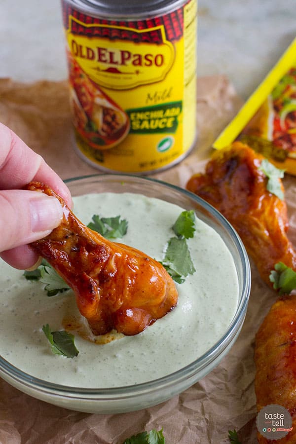 This Enchilada Chicken Wing Recipe takes wings that have been pan fried and bathes them in a slightly spicy enchilada sauce - a great Tex-Mex take on game day food!