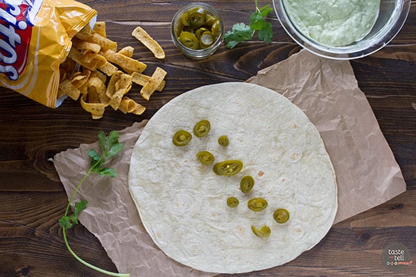 Pickled jalapenos on a tortilla.