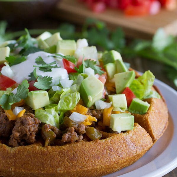 Waffles are not just for breakfast! These savory Taco Cornbread Waffles are topped with ground beef taco mixture and all of your favorite taco toppings. This is a great way to change up taco night!