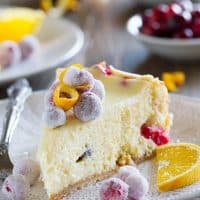 Slice of cranberry orange cheesecake on a plate.