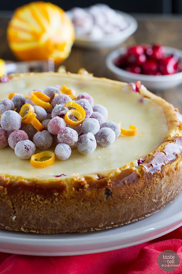 Full cranberry orange cheesecake topped with sugared cranberries.