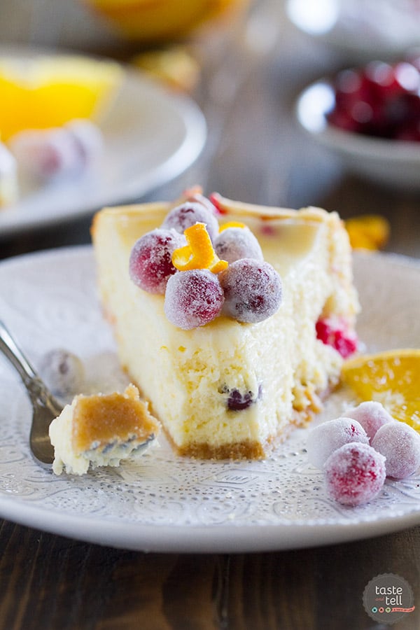 Slice of cranberry orange cheesecake with a forkful taken off the end.