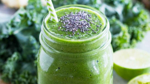 kale smoothie - green smoothie - with a straw and chia seeds in a jar