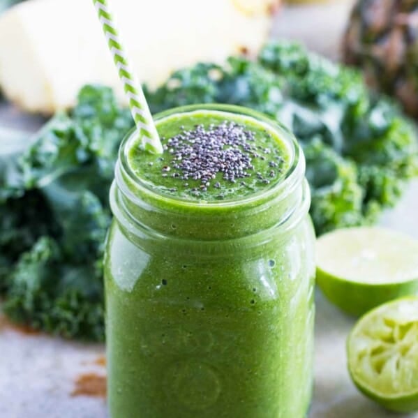 kale smoothie - green smoothie - with a straw and chia seeds in a jar