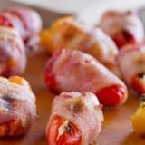 These Sausage Stuffed Peppers have mini peppers that are stuffed with cream cheese and mini smoked sausages, and then are wrapped in bacon for a bite-sized appetizer that will be a total crowd pleaser.