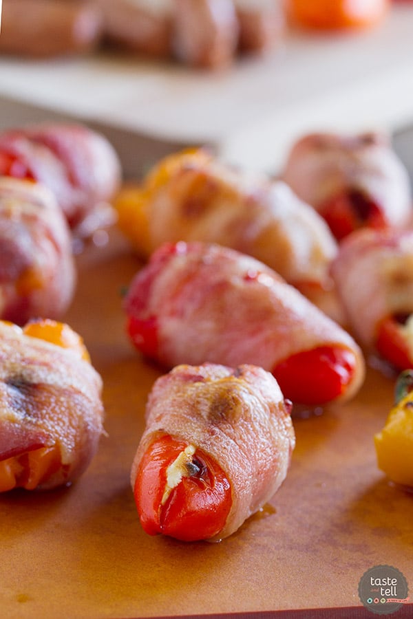 These Sausage Stuffed Peppers have mini peppers that are stuffed with cream cheese and mini smoked sausages, and then are wrapped in bacon for a bite-sized appetizer that will be a total crowd pleaser.