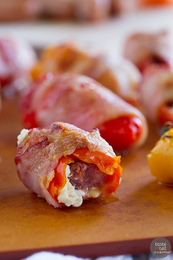 These Sausage Stuffed Peppers have mini peppers that are stuffed with cream cheese and mini smoked sausages, and then are wrapped in bacon for a bite-sized appetizer that will be a total crowd pleaser.