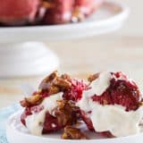 Soft and gooey and a vibrant red, this Red Velvet Pull Apart Bread is perfect for breakfast or for a delicious dessert. Layers of red velvet dough are covered in a gooey cinnamon pecan mixture. Don’t skip the cream cheese icing to top the whole thing off!